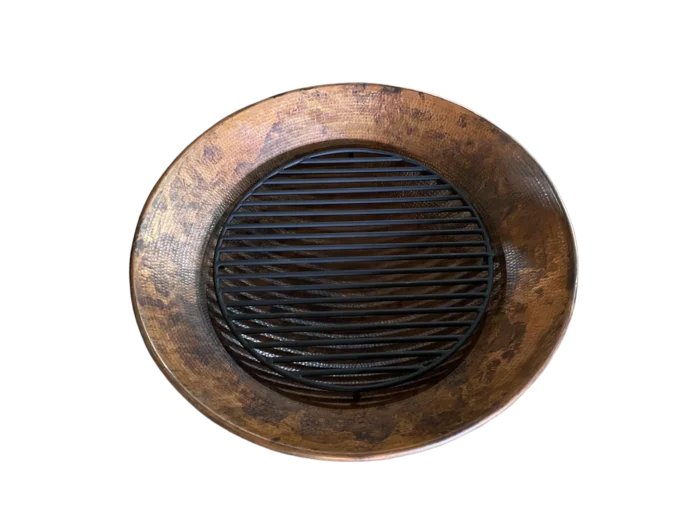 Top view of handcrafted copper fire pit with hammered finish, steel base, and removable grate.