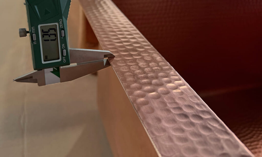 Micrometer measuring the thickness of hammered copper sheet for a kitchen sink 14