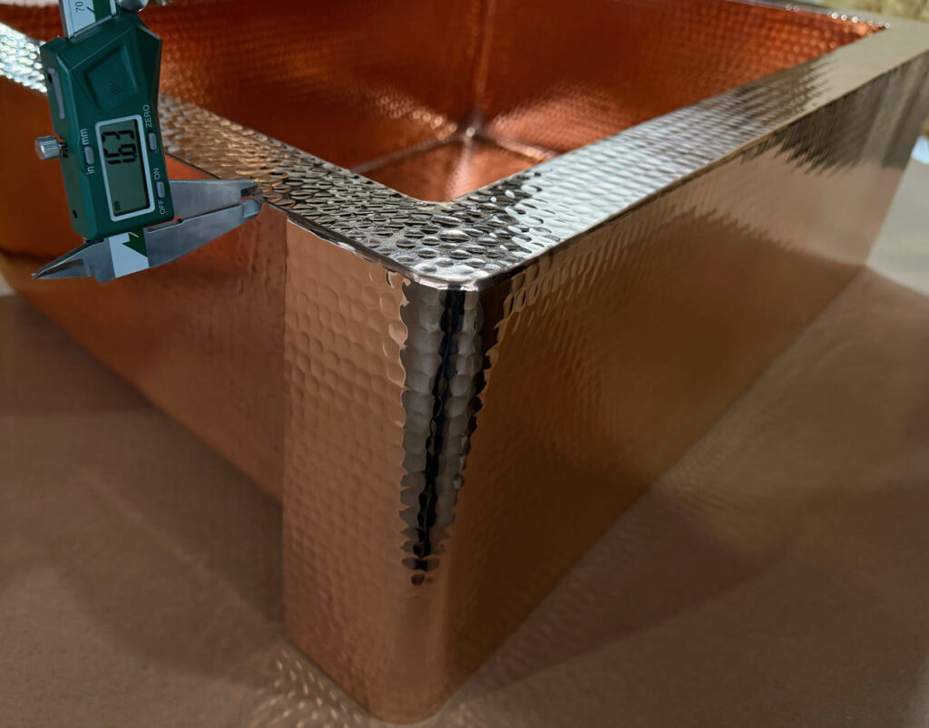 Micrometer measuring the thickness of hammered copper sheet for a kitchen sink 16