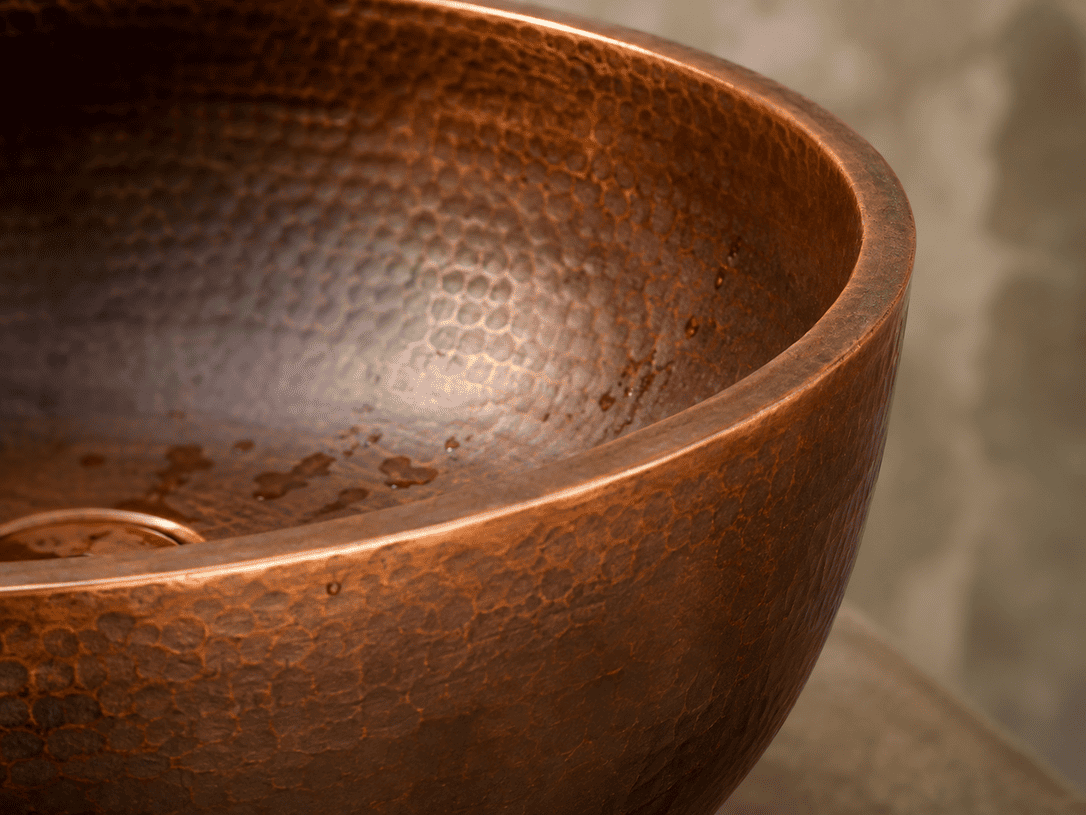 Natural tonal variation on a handcrafted hammered copper living finish