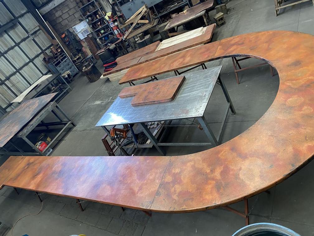Handcrafted copper surface being fabricated for commercial hospitality use