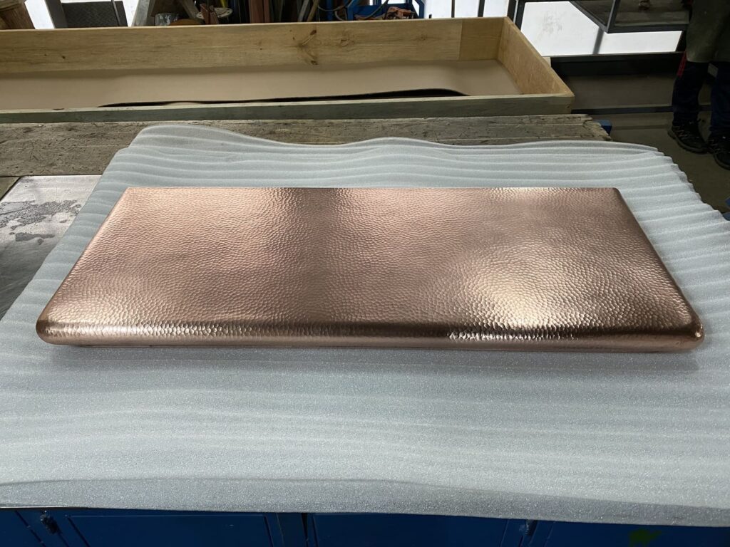 Handcrafted copper countertop showing custom edge profile and natural patina